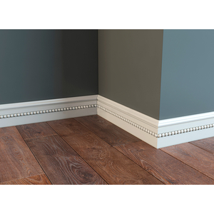 Carved wooden skirting board with a beaded insert